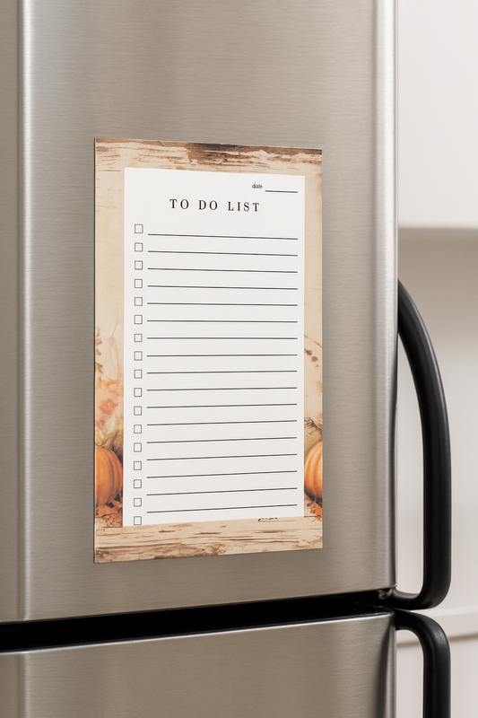 Magnetic To Do List notepad with rustic wood border and watercolor pumpkin design, displayed on a stainless steel refrigerator. Features lined checklist with checkboxes and date section for daily organization and fall-inspired home décor.